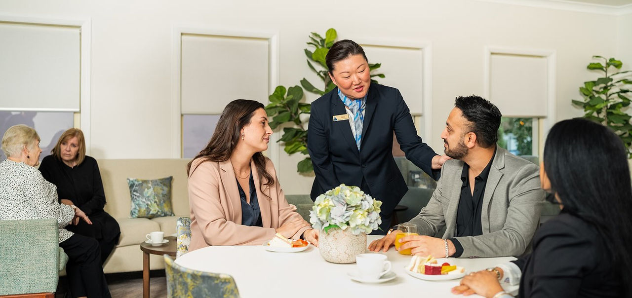 Allan Drew funeral director with mourners at a reception