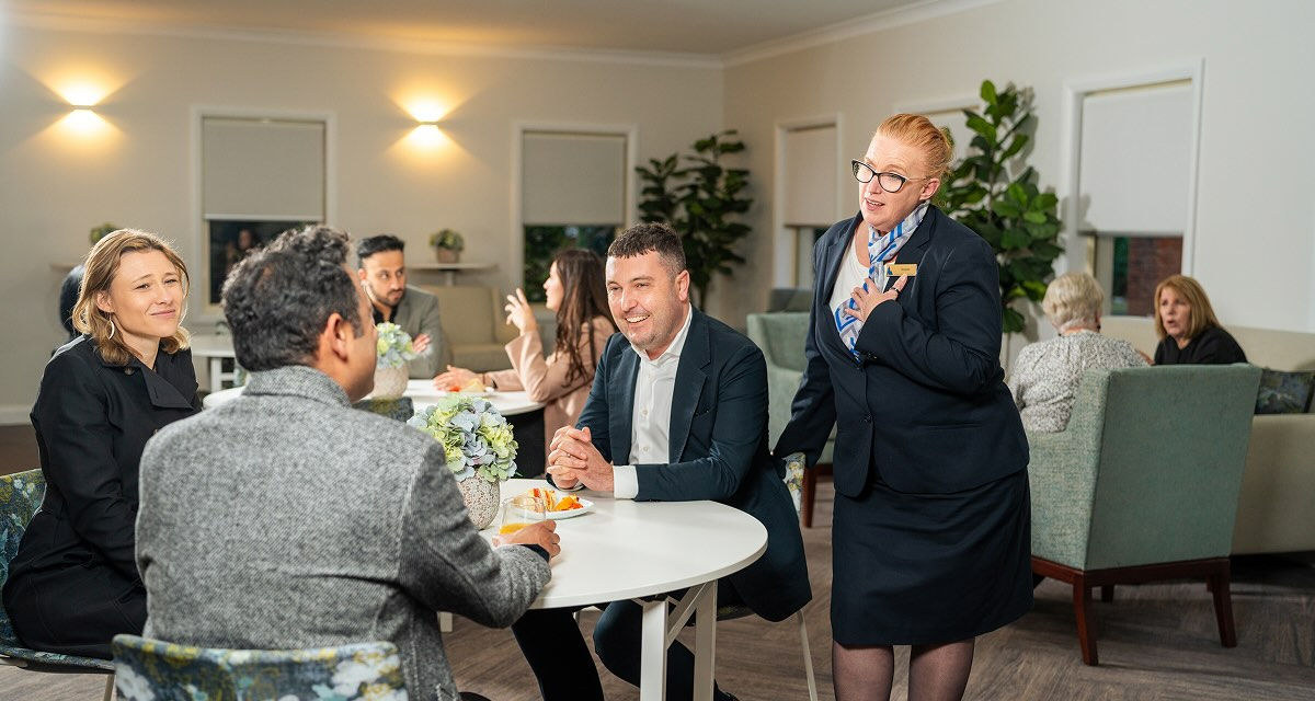 Allan Drew funeral director with mourners at a reception