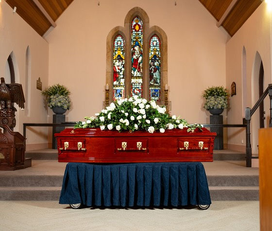 coffin with flower arrangement
