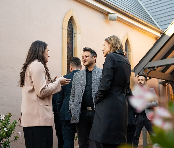 mourners standing outside of the chapel