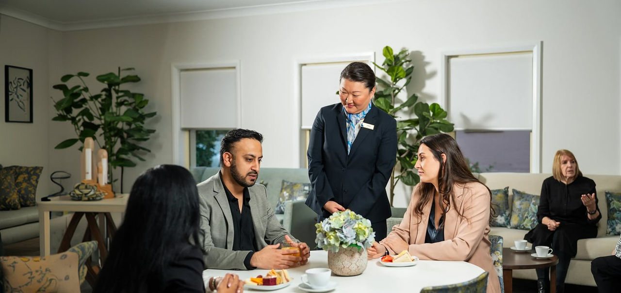 Allan Drew funeral director with mourners at a reception