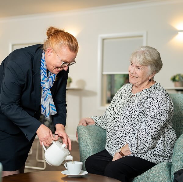 Allan Drew funeral director serving tea to a woman