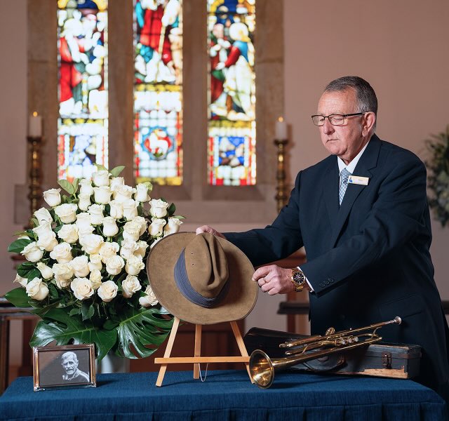 Allan Drew funeral director setting up a table for a funeral