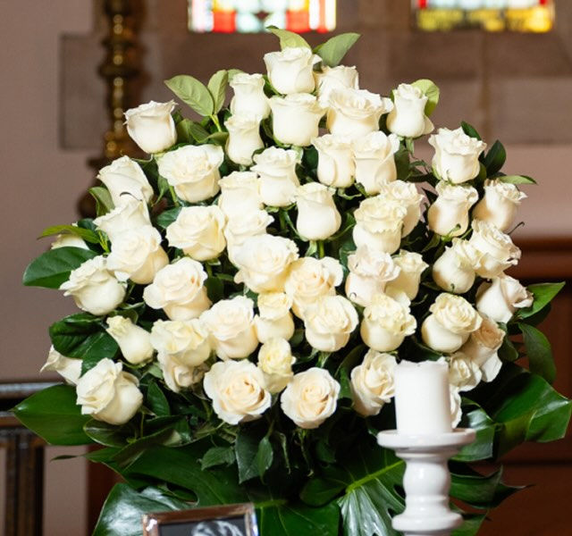 Allan Drew funeral director setting up a table for a funeral